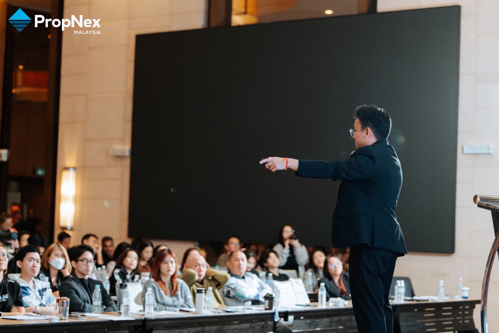 Jacob Ong presenting to a full training room