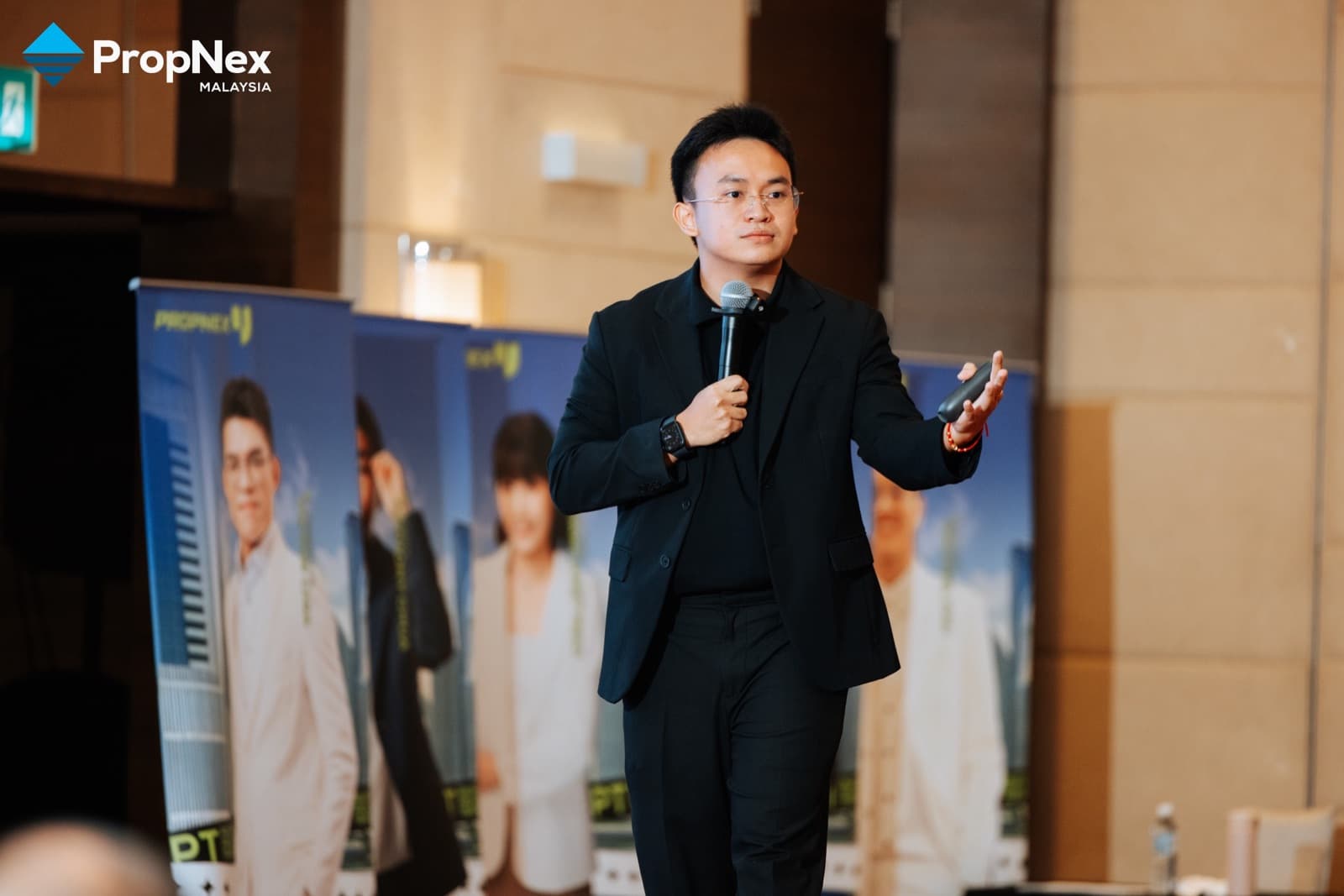 Jacob Ong on stage at PropNex Professional Project Training